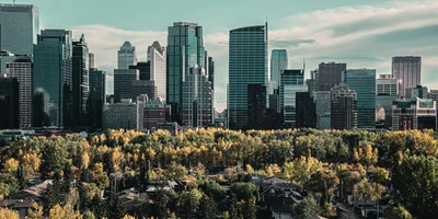 Calgary skyline with autumn trees representing the city’s real estate market trends in 2025.