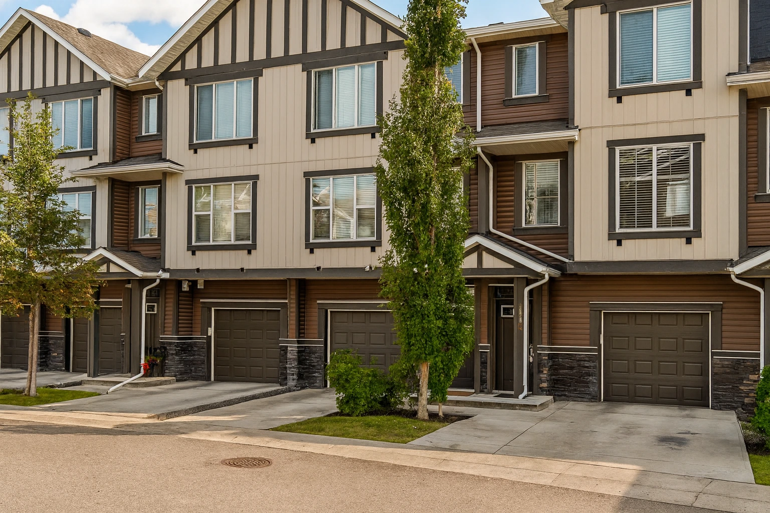 Front exterior view of townhouse at 173 New Brighton Walk SE Calgary with garage and modern design.