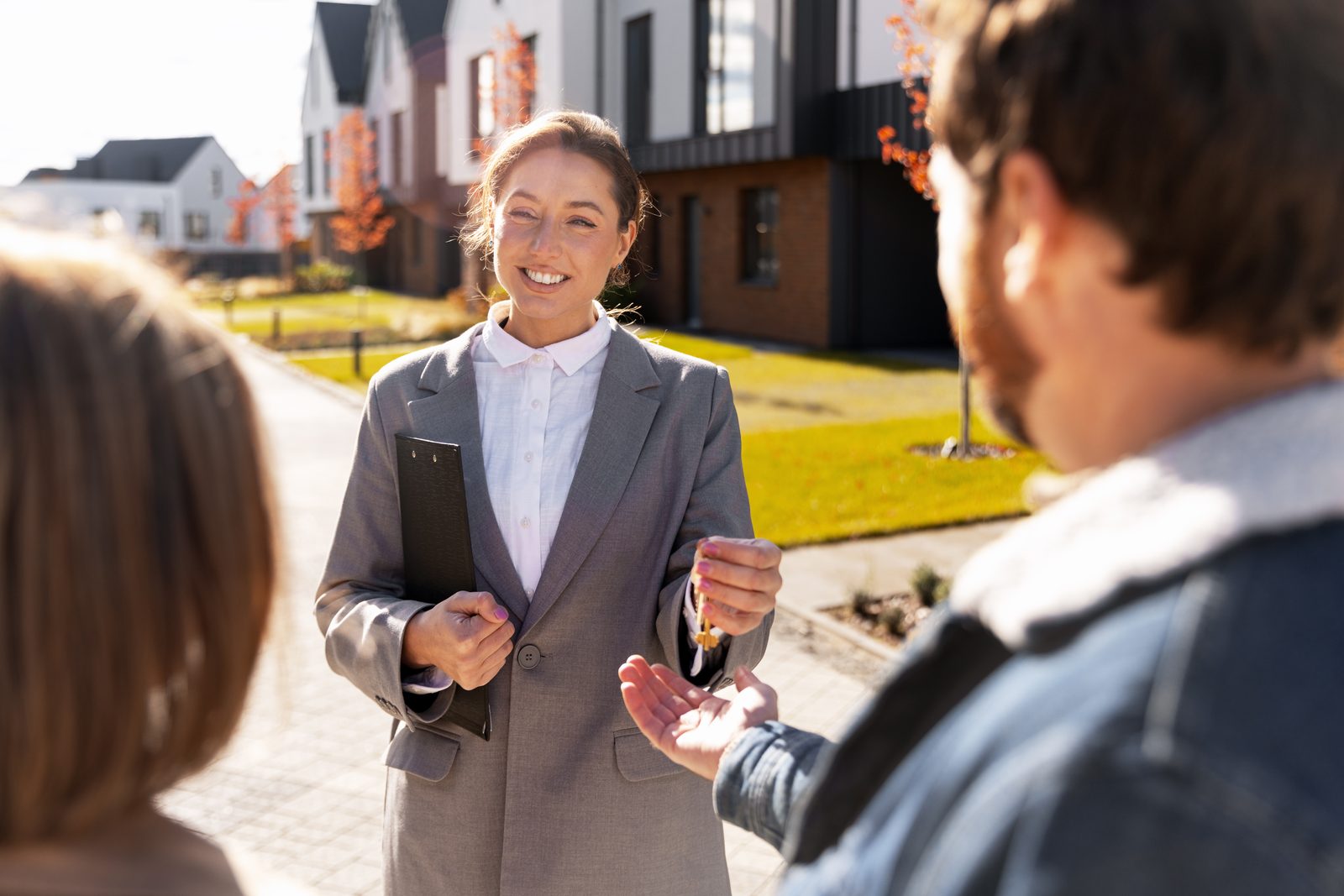 Real estate agent handing house keys to a new homeowner in Calgary