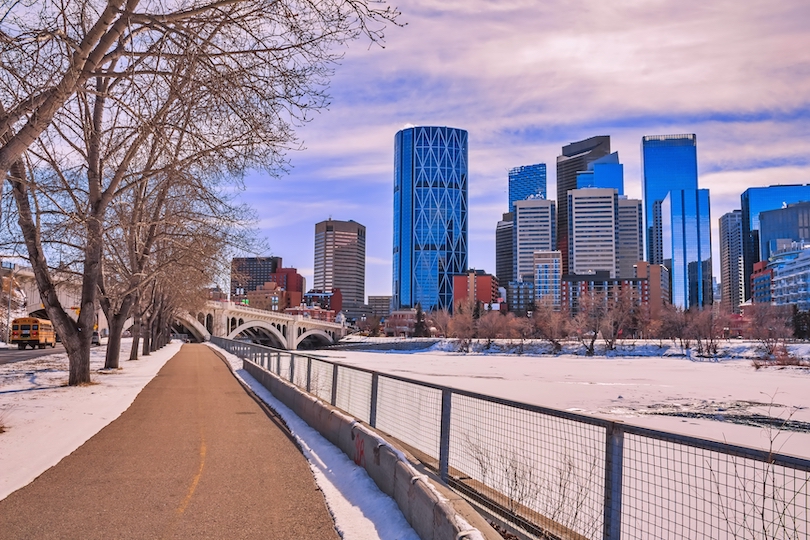 Bow River pathway near Bowness Park in Calgary with trees lining the riverside trail