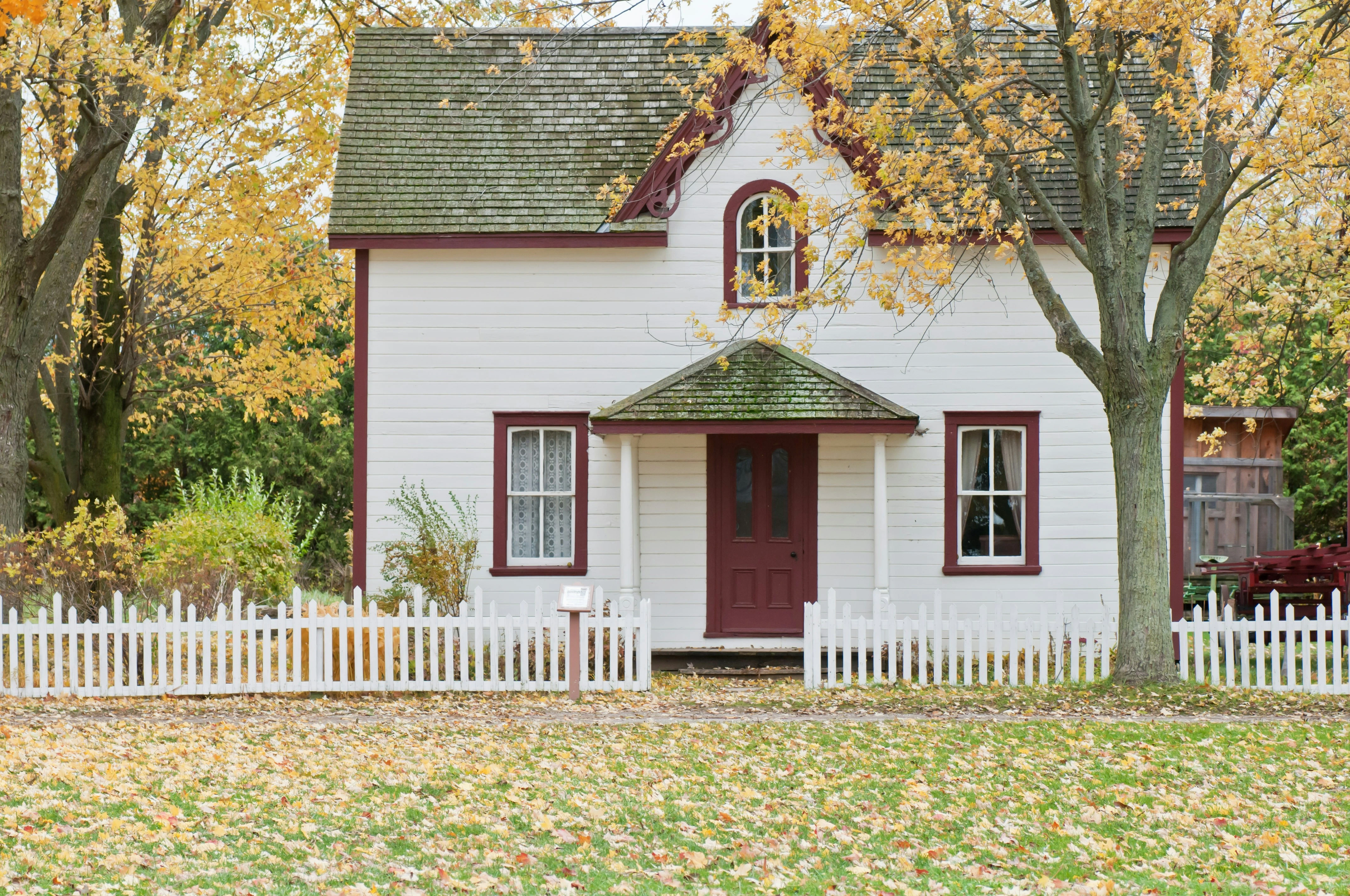 ingle detached Calgary home surrounded by fall leaves symbolizing residential property value in 2025.