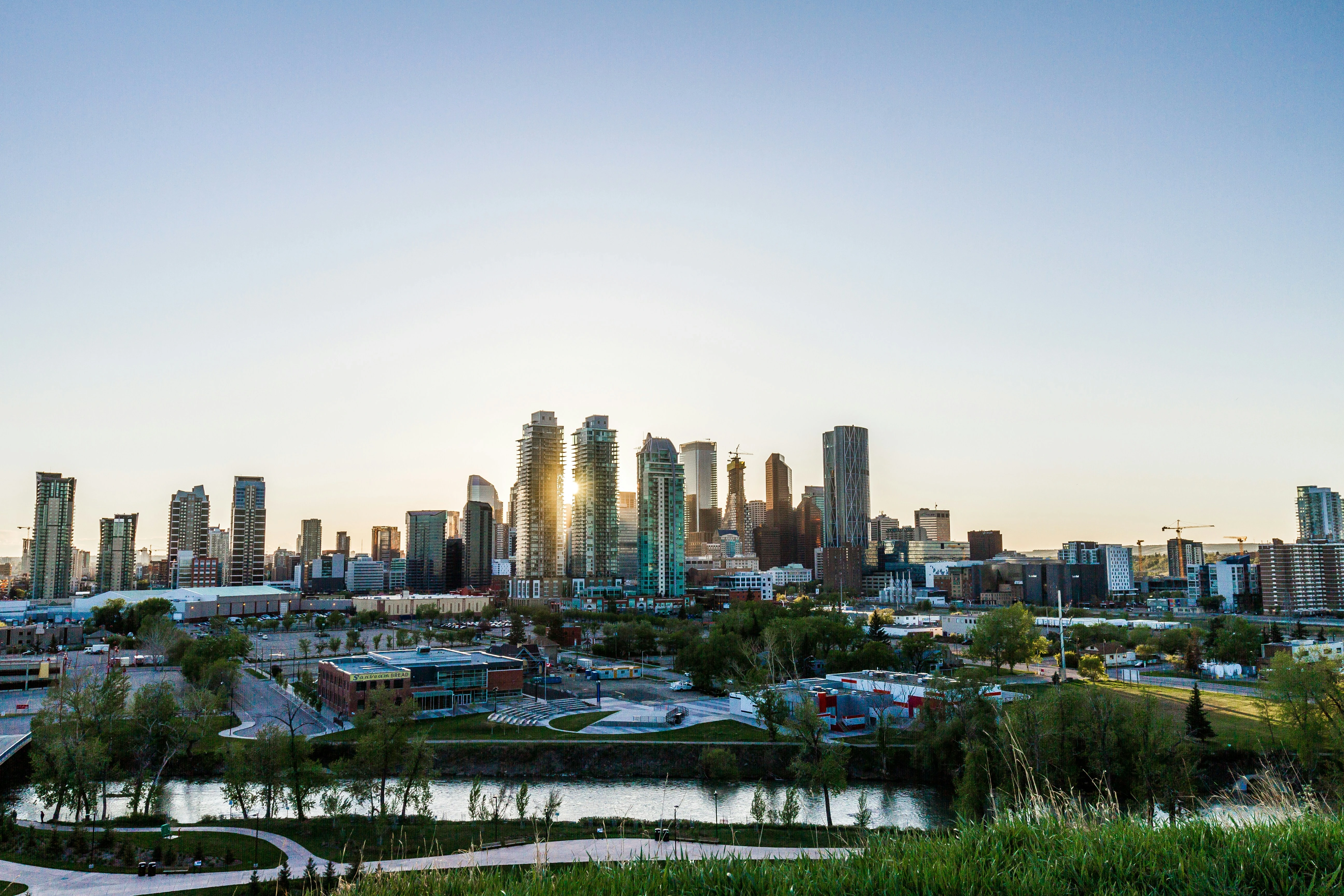 Calgary skyline at sunset, highlighting city neighbourhoods with affordable housing options.