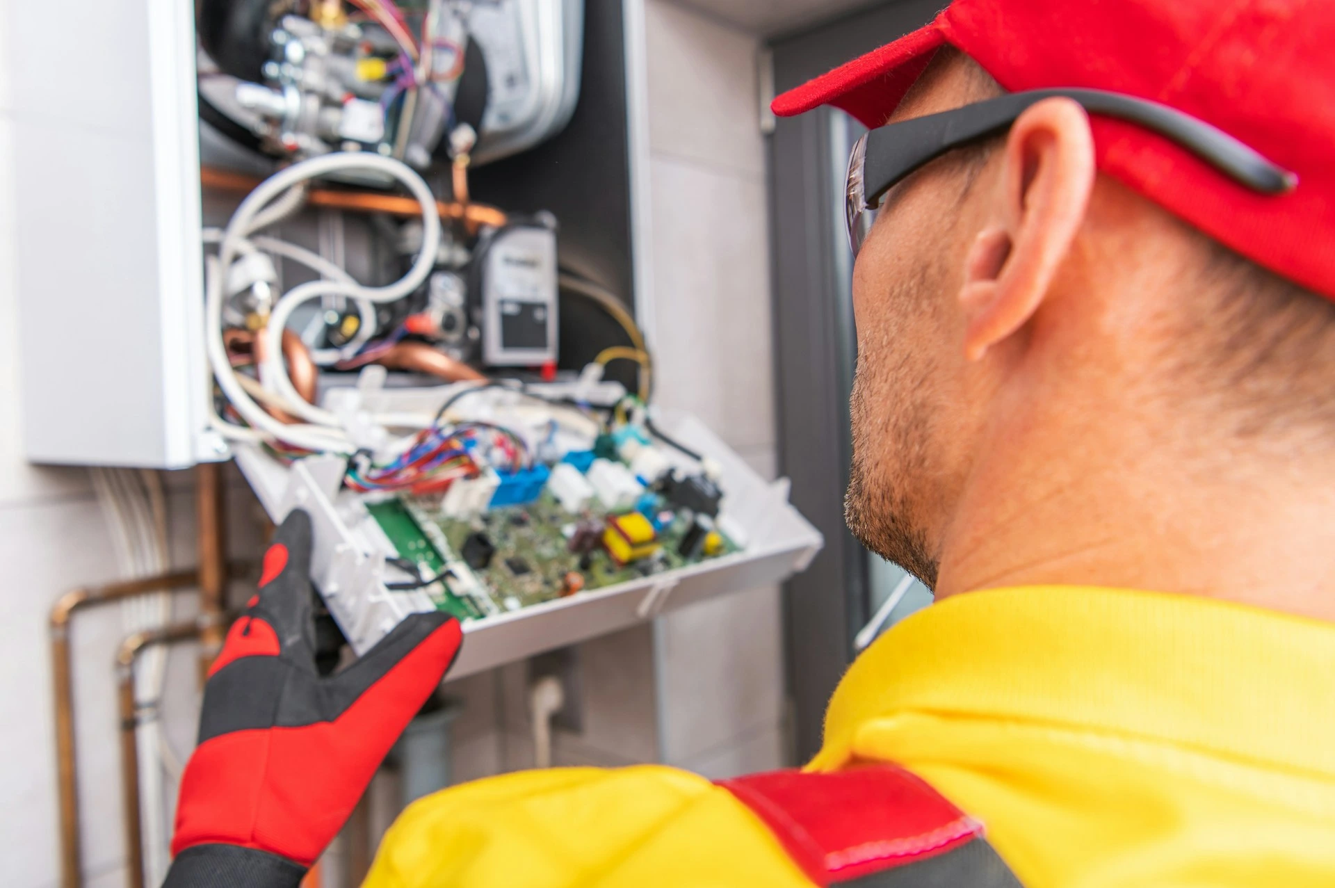 Professional technician inspecting a home furnace system during fall maintenance in Calgary.