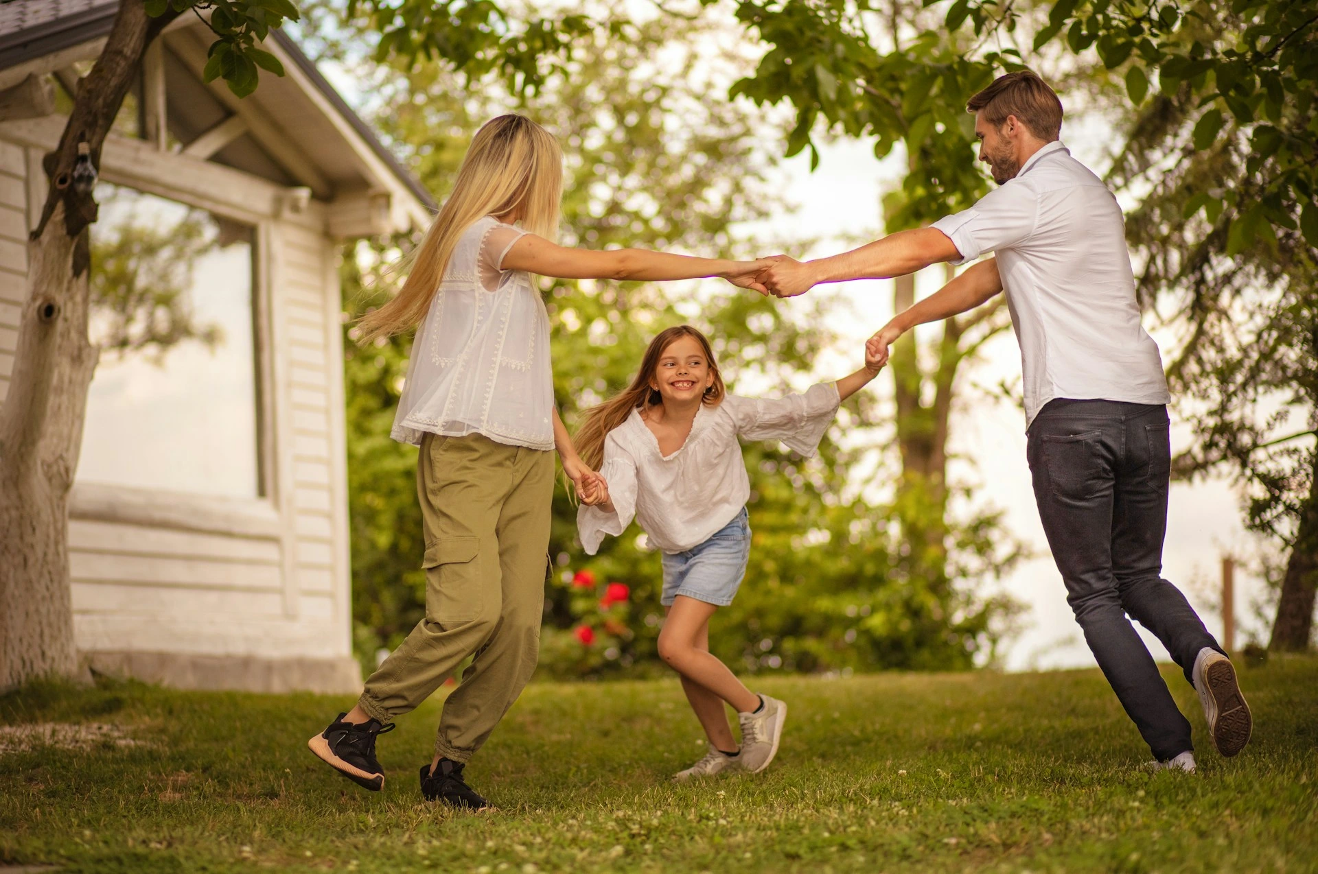 Family playing together in the yard of their detached home in Calgary.