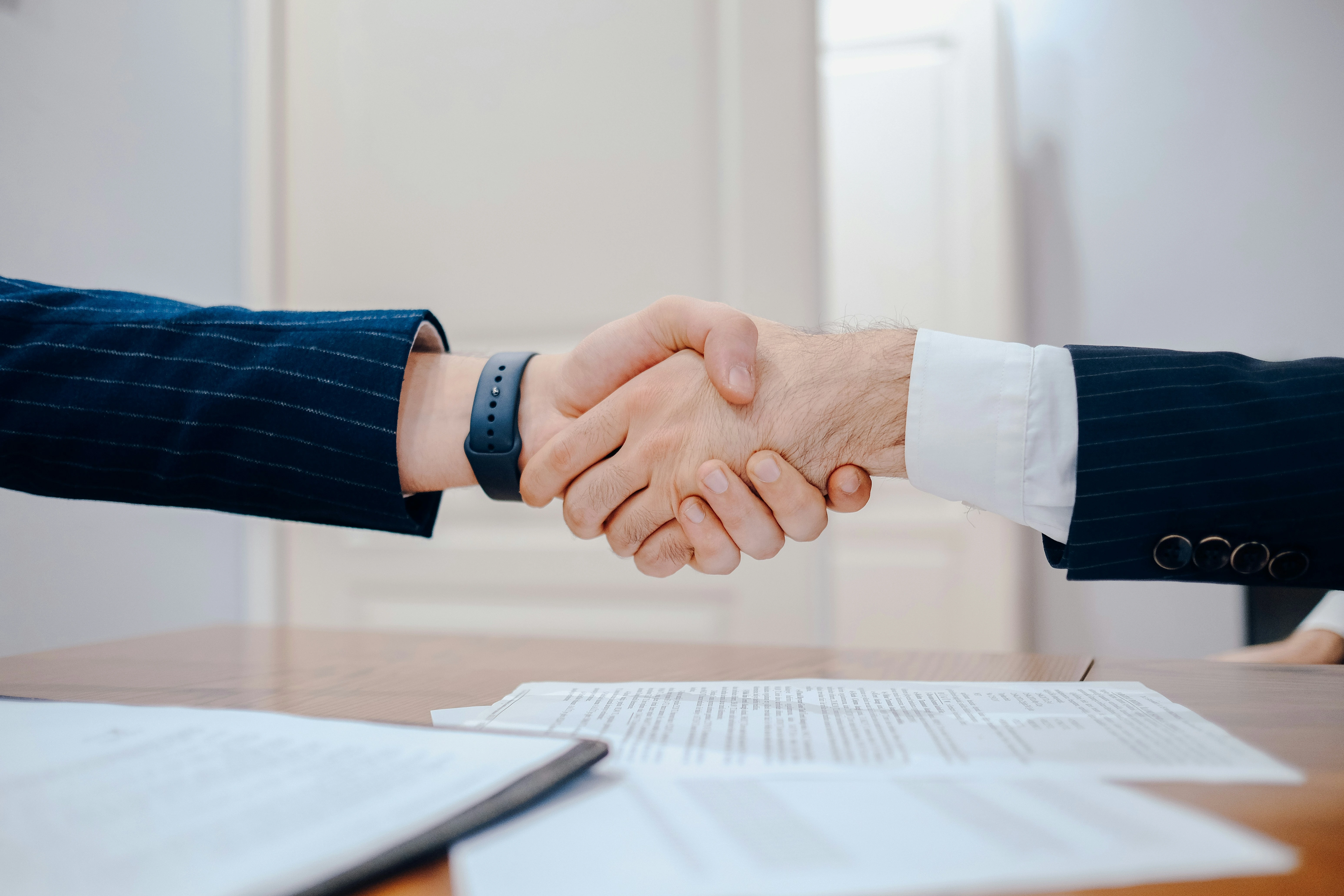 Handshake symbolizing real estate agreement between buyer and seller in Calgary.
