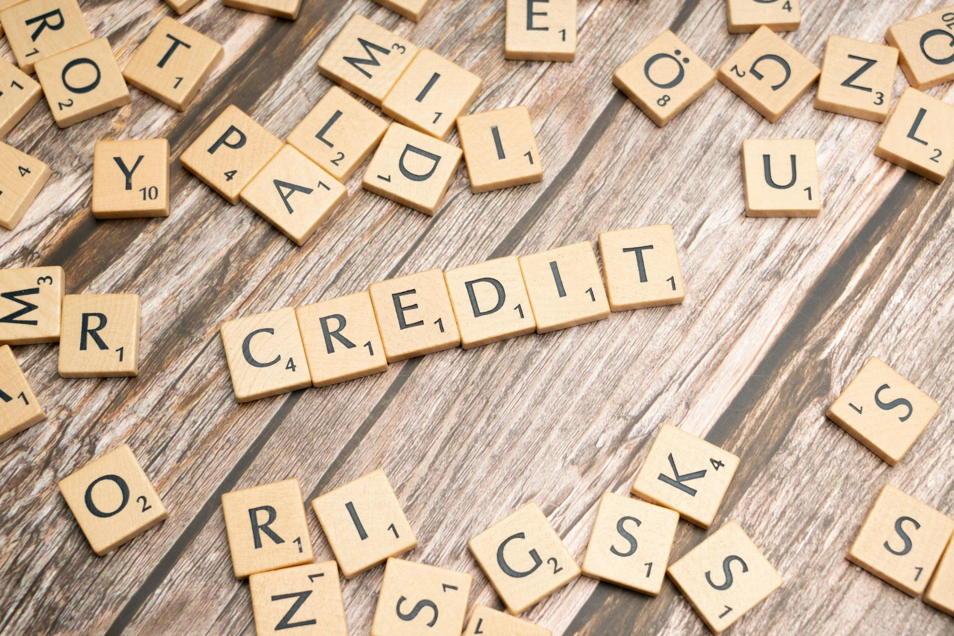 Wooden letter tiles spelling ‘credit,’ illustrating the importance of credit scores in the Calgary mortgage pre-approval process.