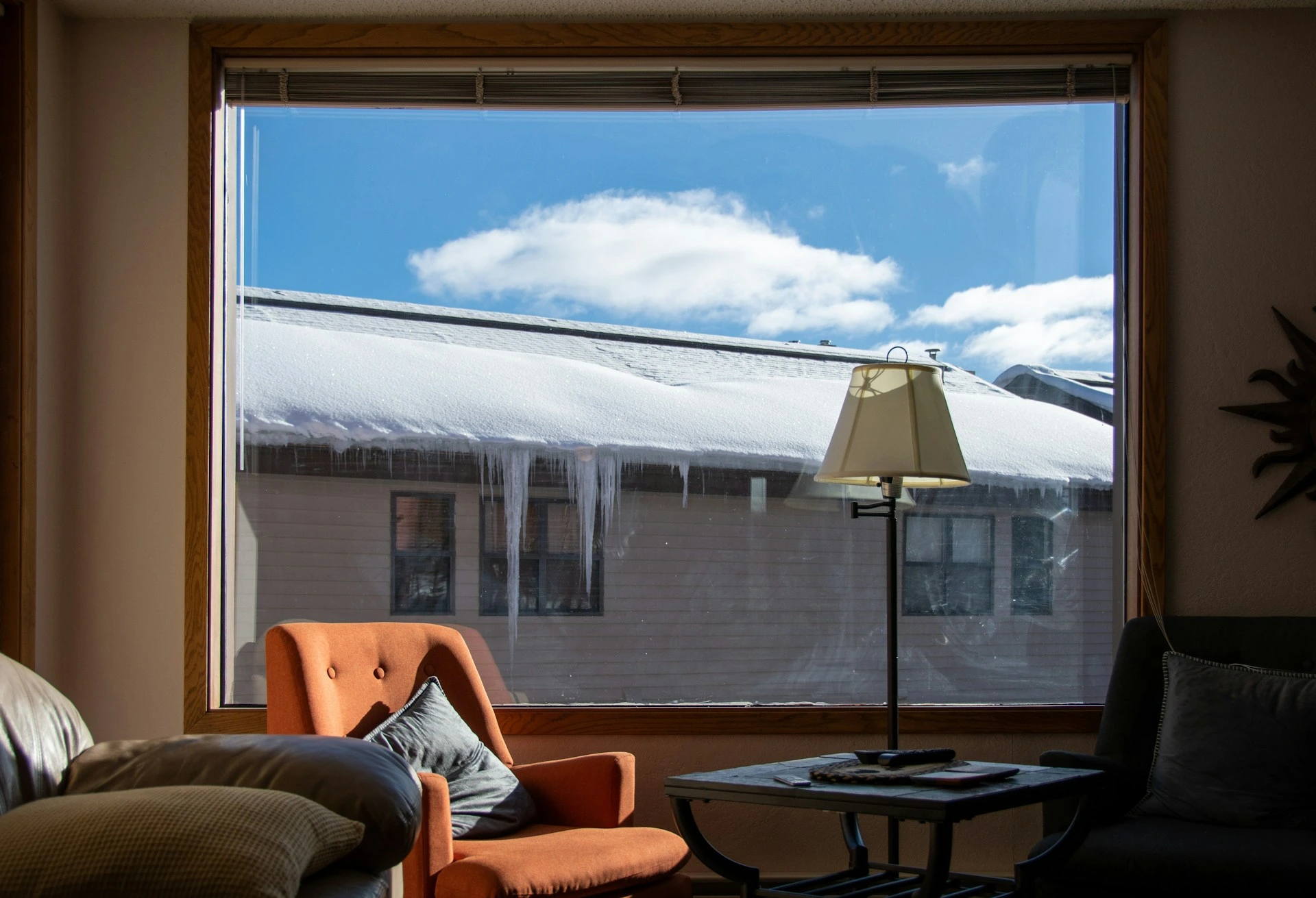 Large window with bright winter sunlight shining into a living room, showing how to maximize natural light when staging a Calgary home.
