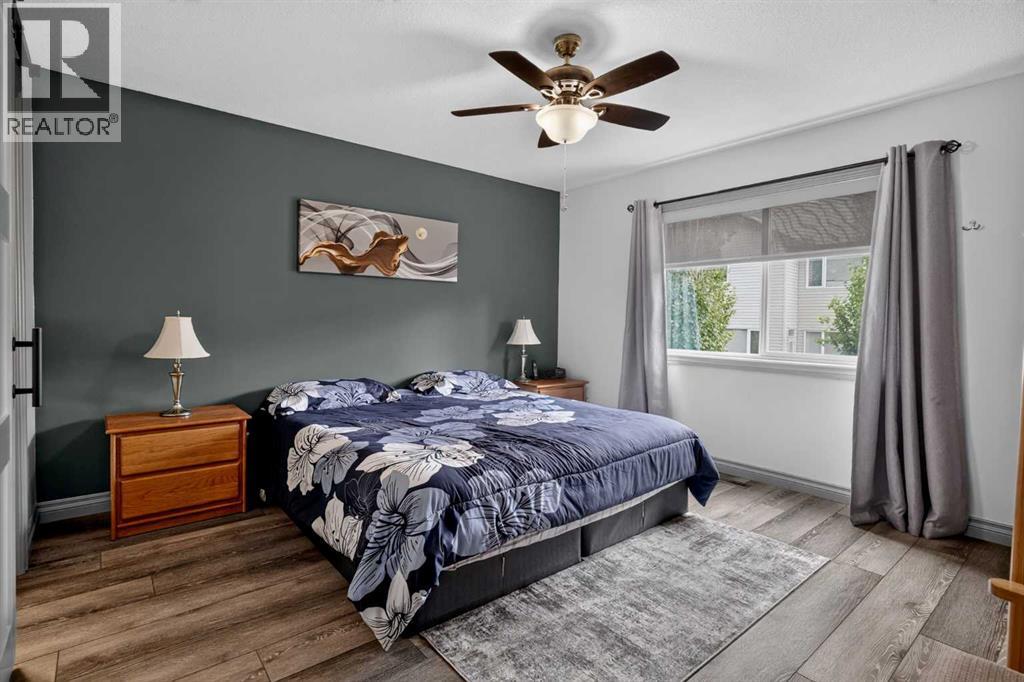 Spacious primary bedroom with large windows