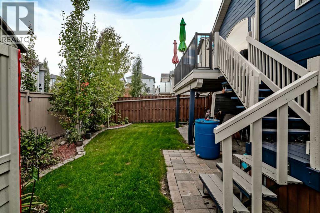 Landscaped fenced backyard with patio at 226 Cimarron Drive, Okotoks