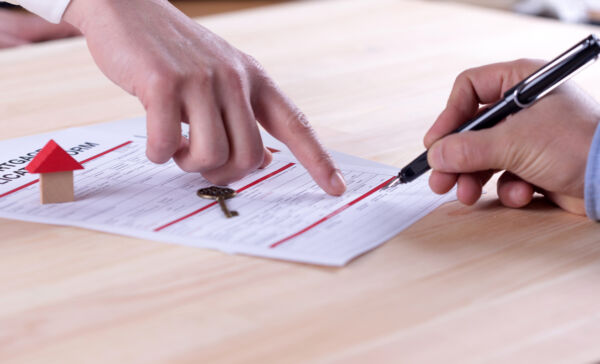 Buyer reviewing condo documents and monthly budget details before purchasing a Calgary condo