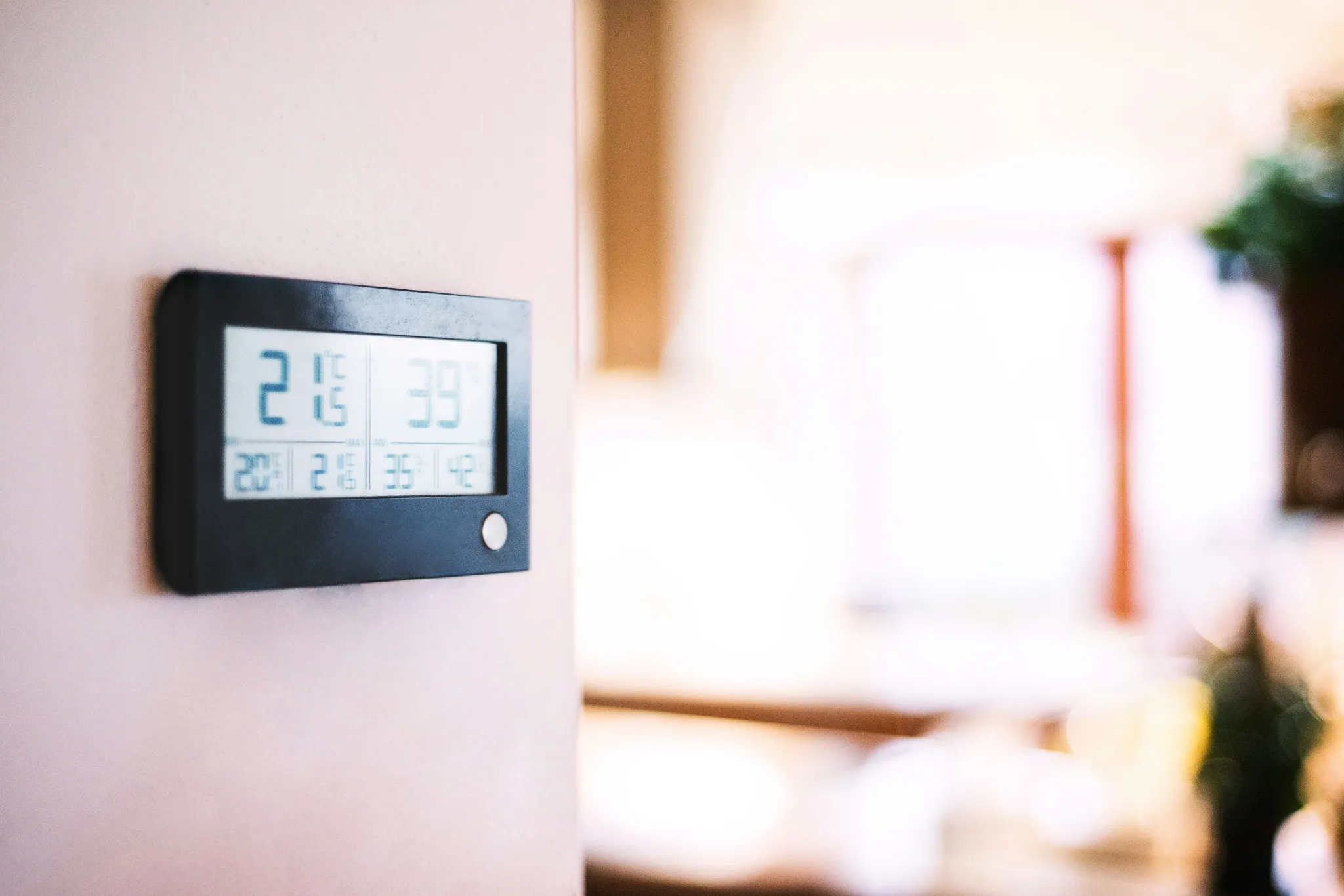 Smart thermostat on wall helping reduce energy costs at home.