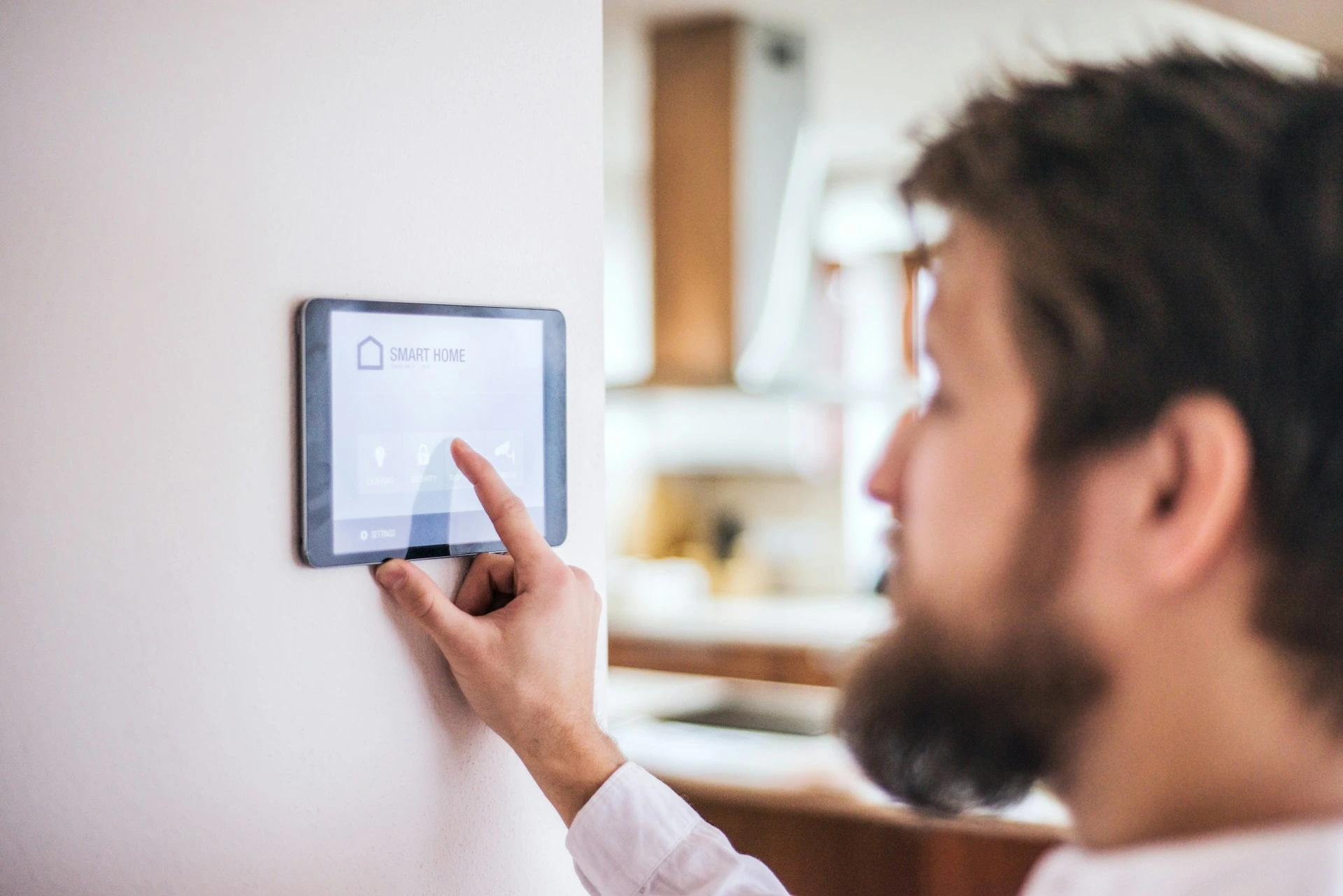 Homeowner adjusting smart thermostat to prepare furnace and heating system for Calgary winter.