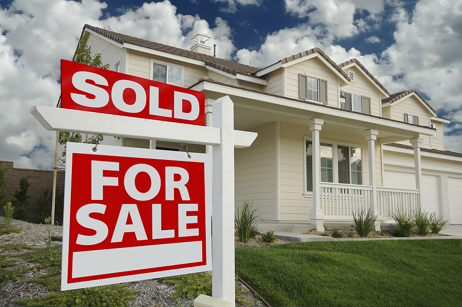 Suburban single-family home with a SOLD sign in an established Calgary neighbourhood like Beddington Heights