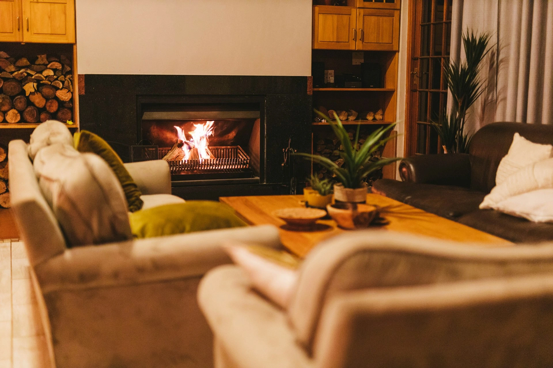 Cozy living room with fireplace and fall d&eacute;cor, showing a warm Calgary home during heating season.