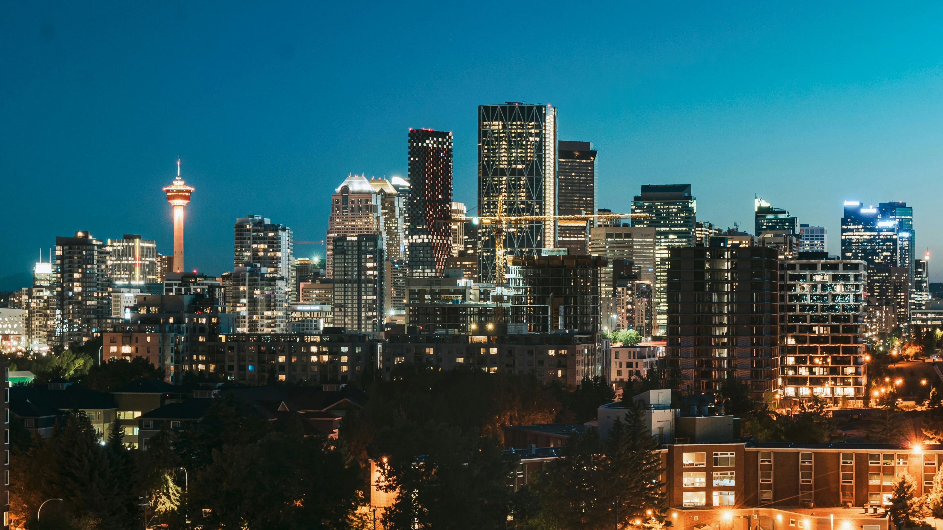 Calgary skyline at night highlighting the city’s real estate market in 2025.