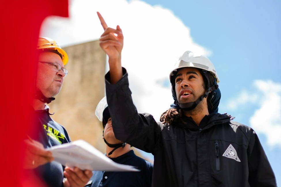 Calgary home inspector in hard hat reviewing property with seller, symbolizing inspection tips for homeowners.