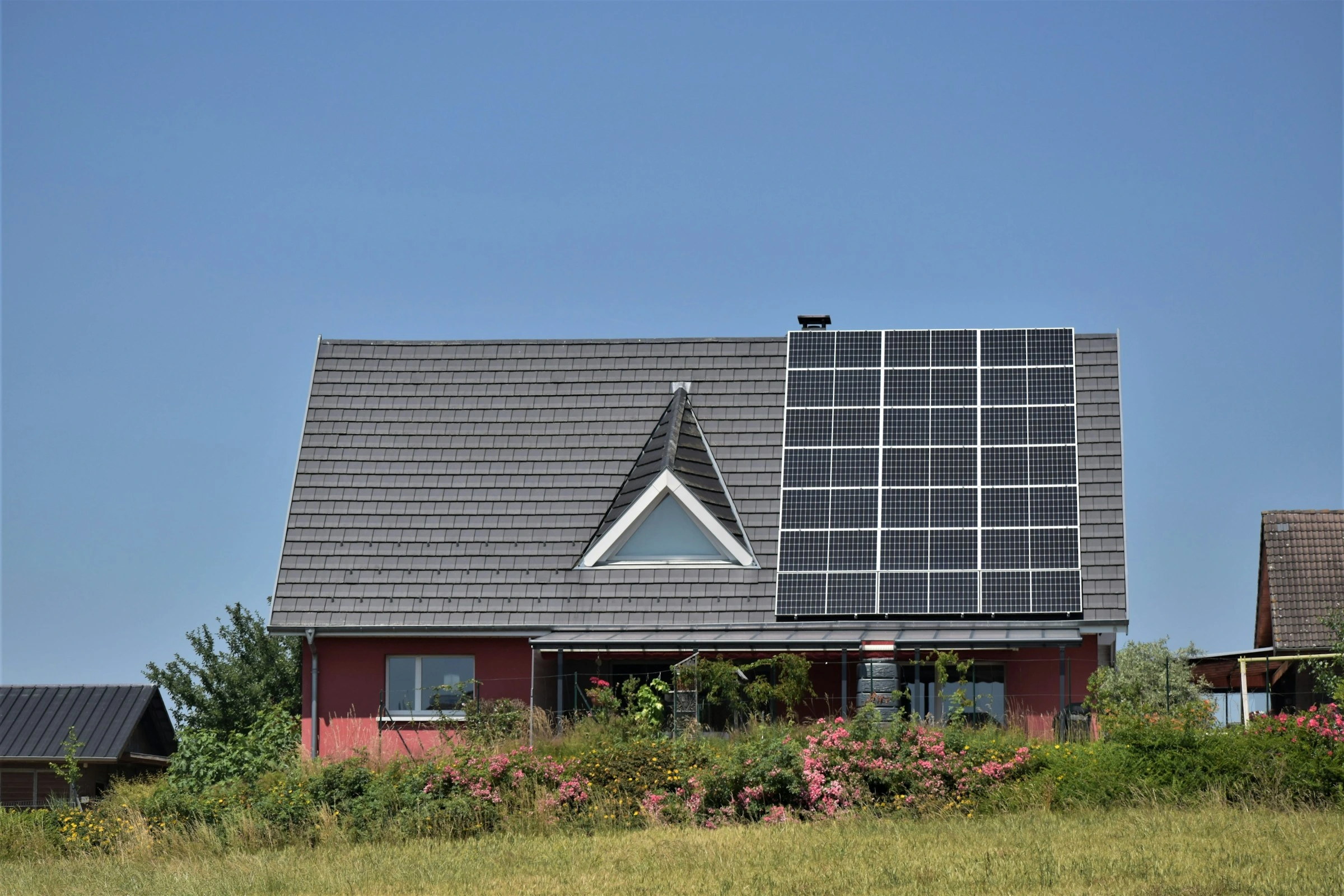 Solar panels on a Calgary home rooftop under bright sun, symbolizing eco-friendly energy investment.