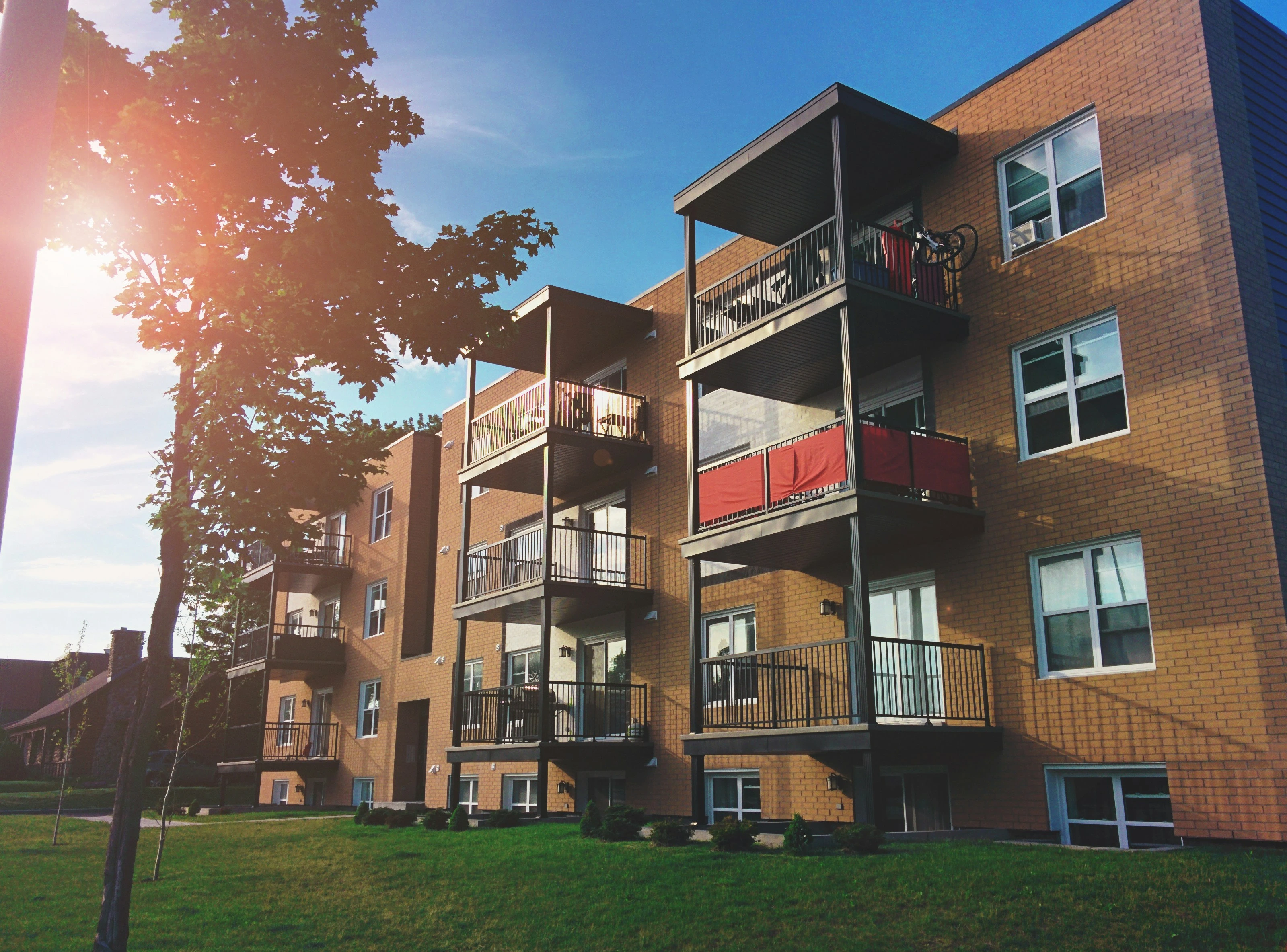 Modern Calgary apartment building with balconies, representing homeownership and the importance of title insurance in Alberta real estate.